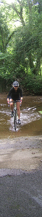 Cyclist pedallin through a ford, Pembrokeshire